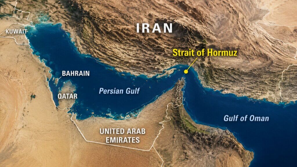 Satellite-style map labeled “Strait of Hormuz” showing the narrow waterway between Iran and Oman connecting the Persian Gulf to the Gulf of Oman. Country names including Iran, Kuwait, Bahrain, Qatar, and United Arab Emirates are marked on the map.