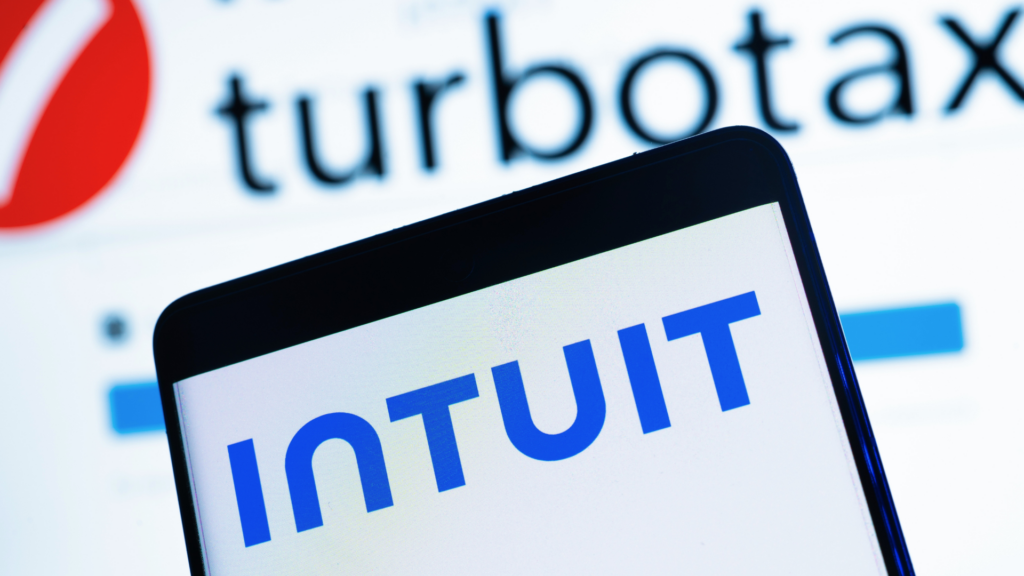 Close-up of a smartphone screen displaying the blue "INTUIT" logo, with the "turbotax" logo blurred in the background.
