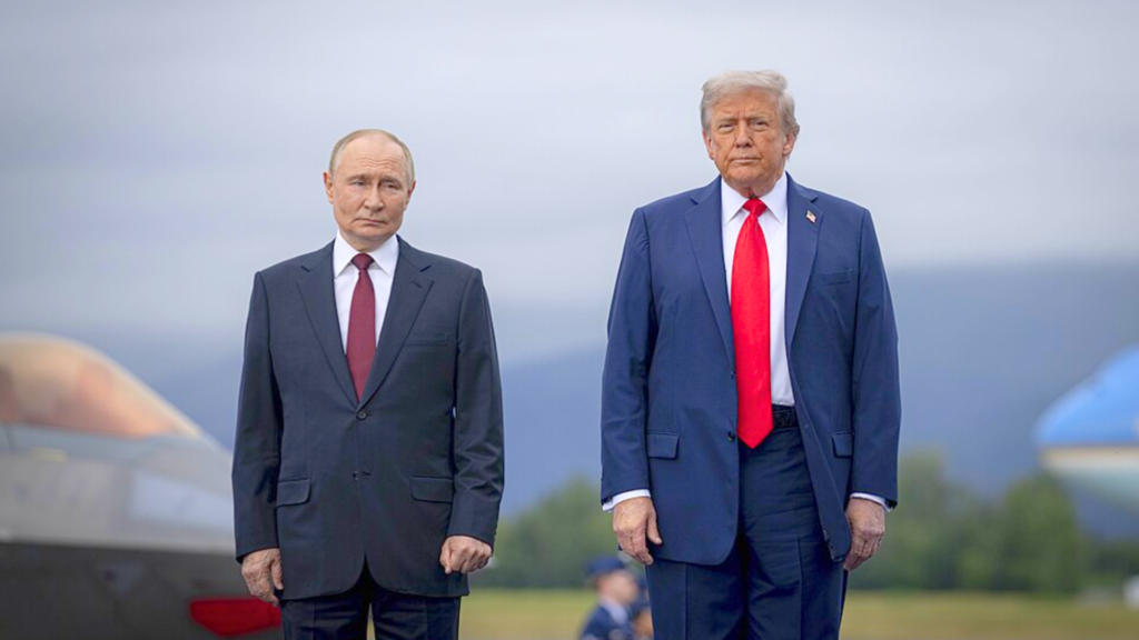 Vladimir Putin and Donald Trump standing side-by-side outdoors with portions of aircraft visible in the background.