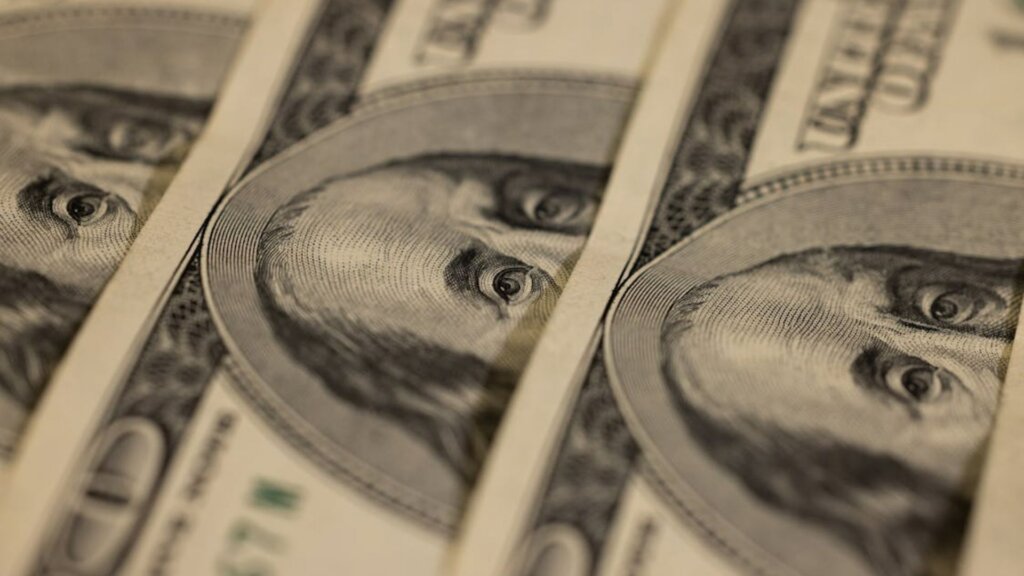 Close up of stacked hundred dollar bills.