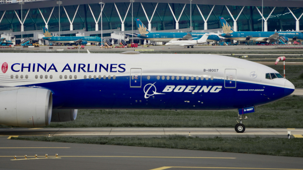 A close-up view of the front section of a China Airlines Boeing 777-300ER airplane taxiing on the tarmac.