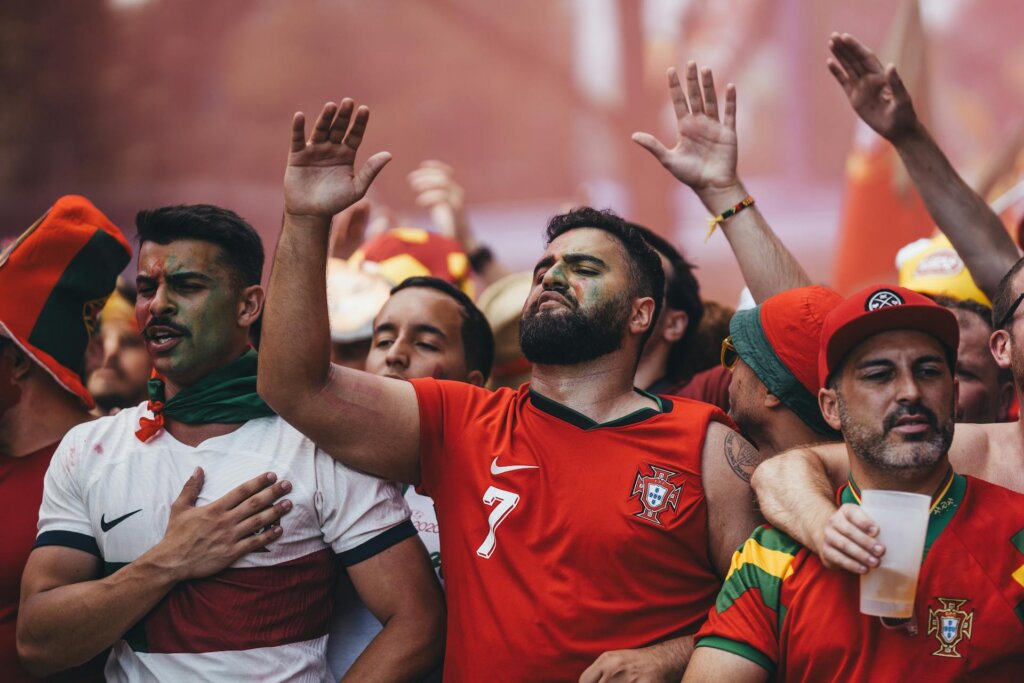 Soccer fans cheering and singing during a FIFA World Cup match.