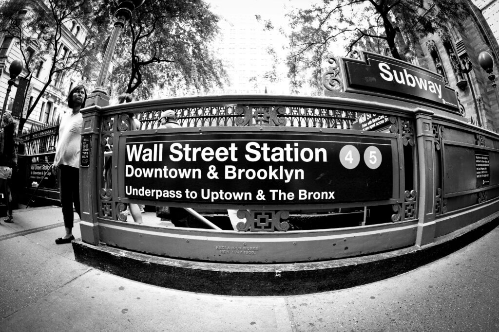 Wall Street subway station entrance sign for lines 4 and 5 in New York City.