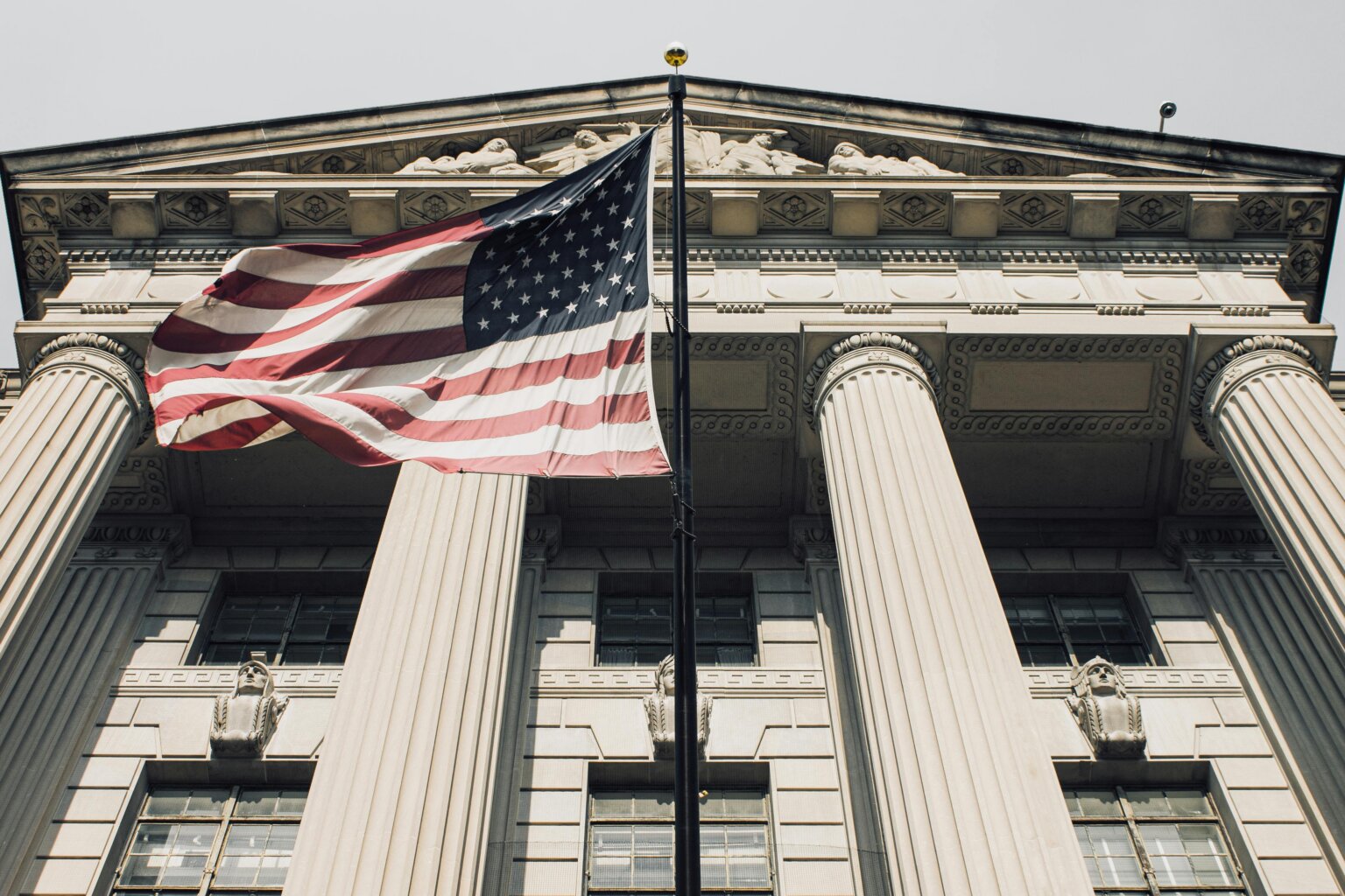 American flag flying in front of the US Supreme Court.