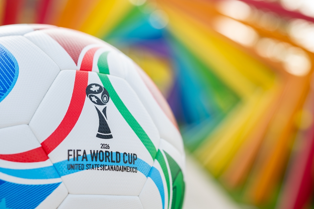 2026 FIFA World Cup soccer ball with rainbow-colored background.