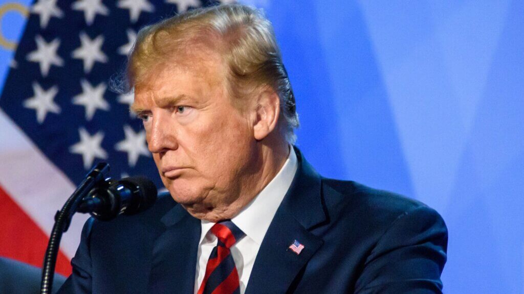 Close take of president Donald Trump in a conference room.