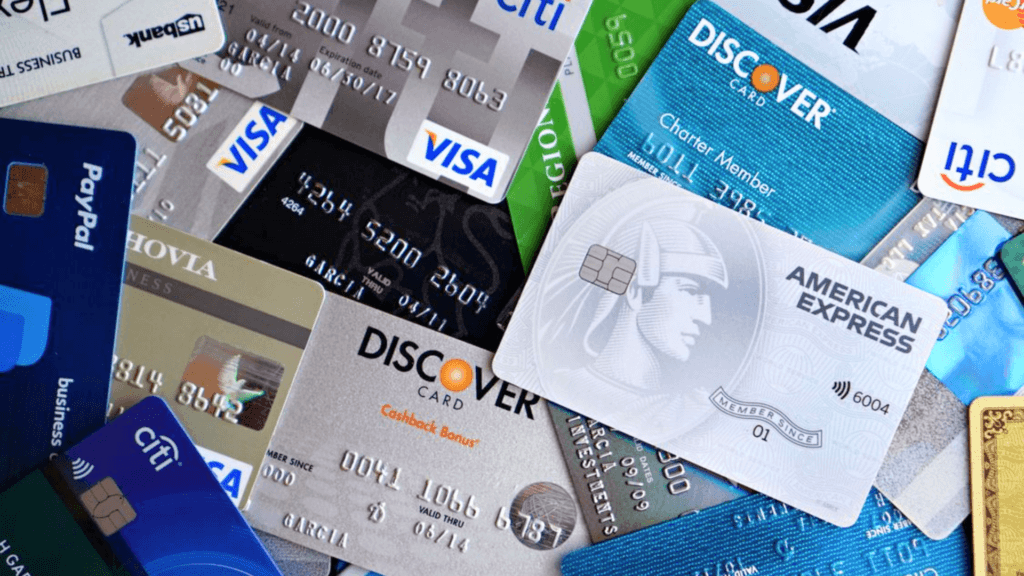 A scattered pile of various credit cards from major providers.