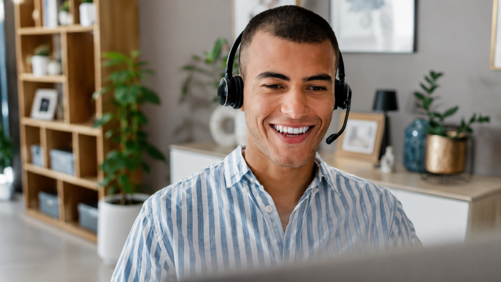 A customer service representative working remotely at a computer, providing online support and assistance to customers.