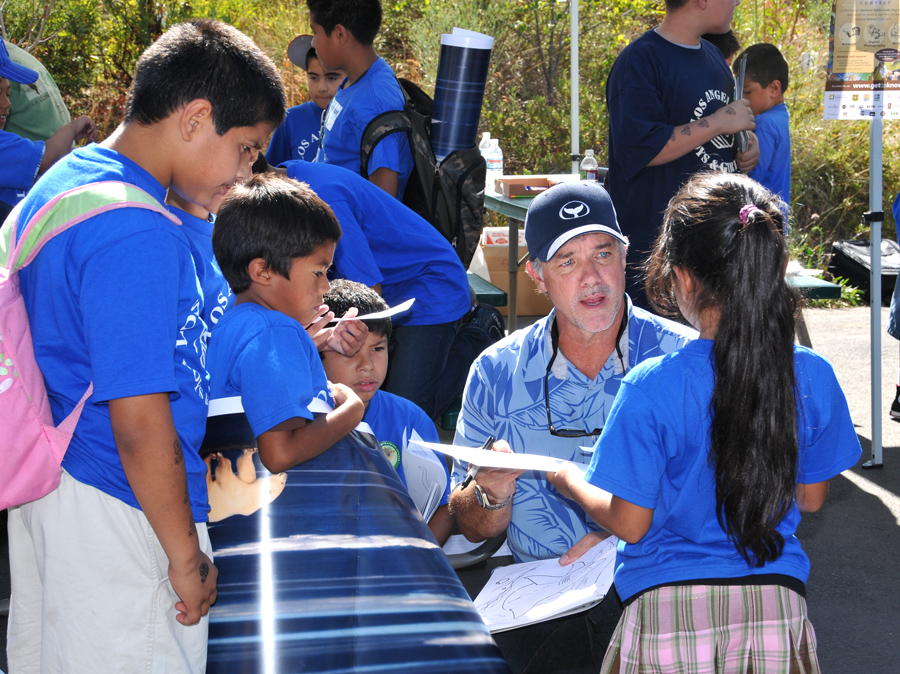 Wyland teaches drawing techniques to children during the Get to Know launch event at the Los Angeles Zoo.