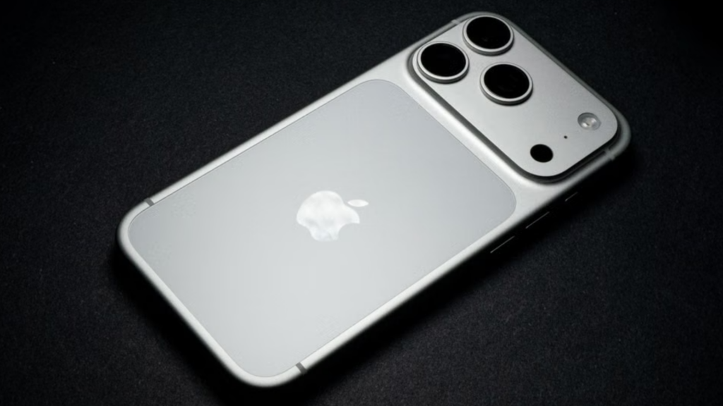 The matte-finished back panel of a silver iPhone Pro model resting on a black surface, highlighting its triple-lens camera array and central Apple logo.