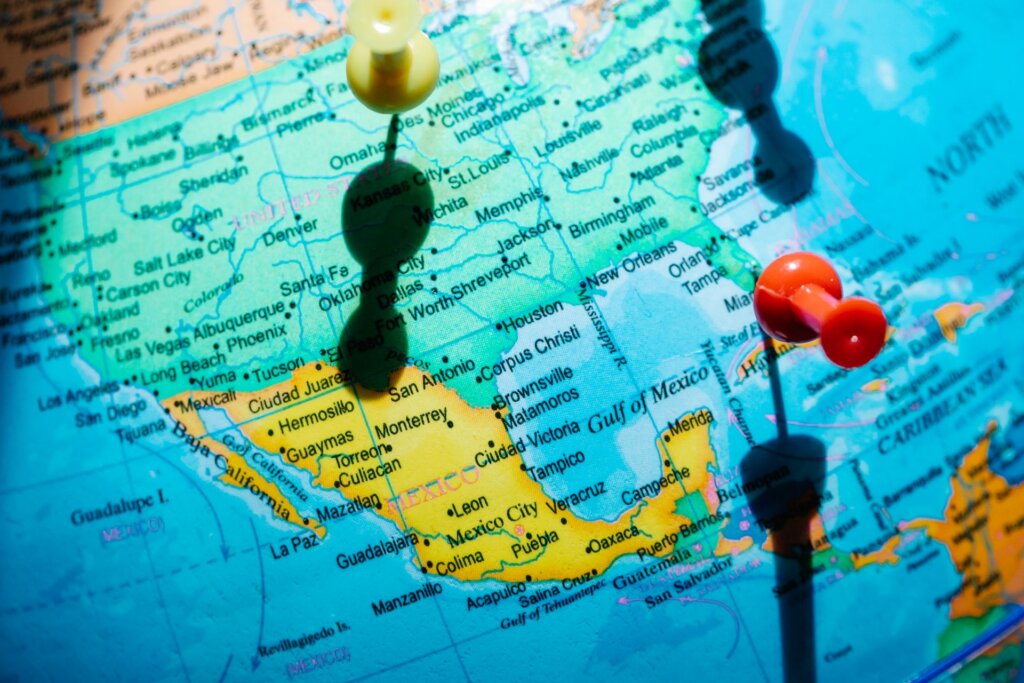 Pushpins marking locations on a map of North America, with the United States and Mexico in view.