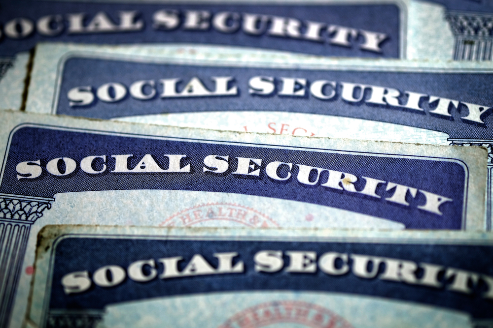 Close-up of multiple Social Security cards stacked together.