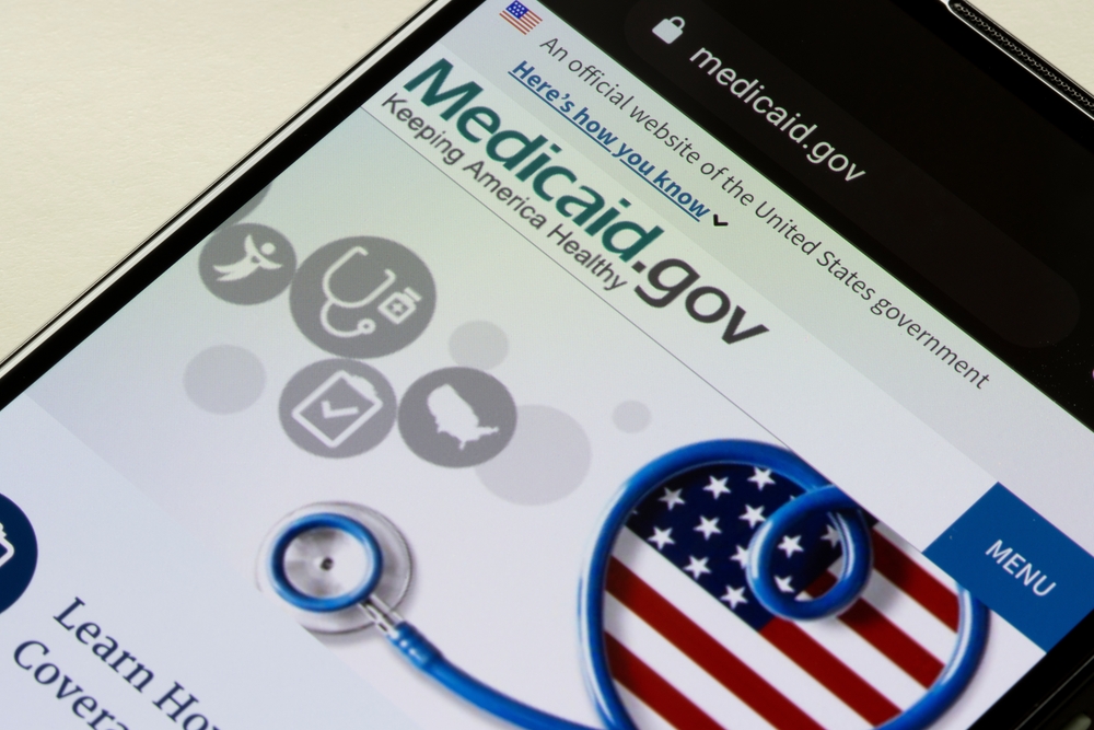 Medicaid.gov website displayed on a smartphone screen, showing information about U.S. government health coverage programs.