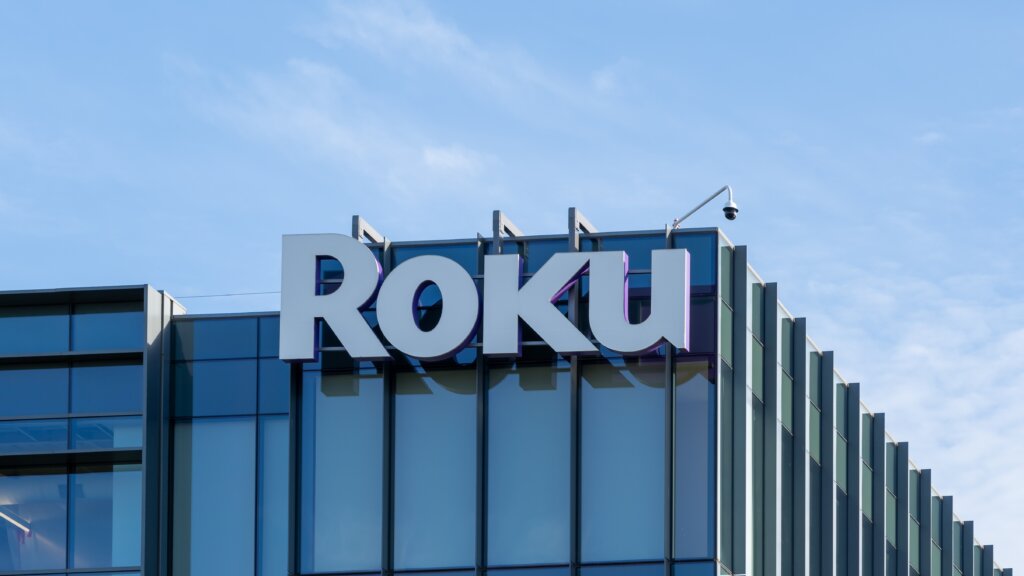 Roku logo displayed on the exterior of a company office building with a glass facade.