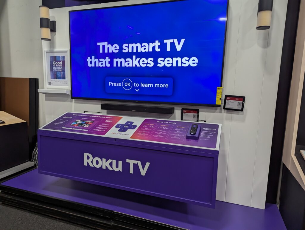 Roku TV display in a retail store showcasing smart TV features and streaming capabilities.
