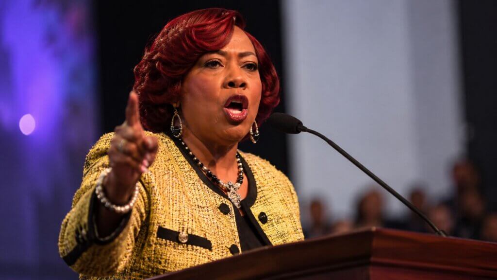 Dr. Bernice A. King speaks passionately at a podium, pointing toward the audience while delivering a speech.
