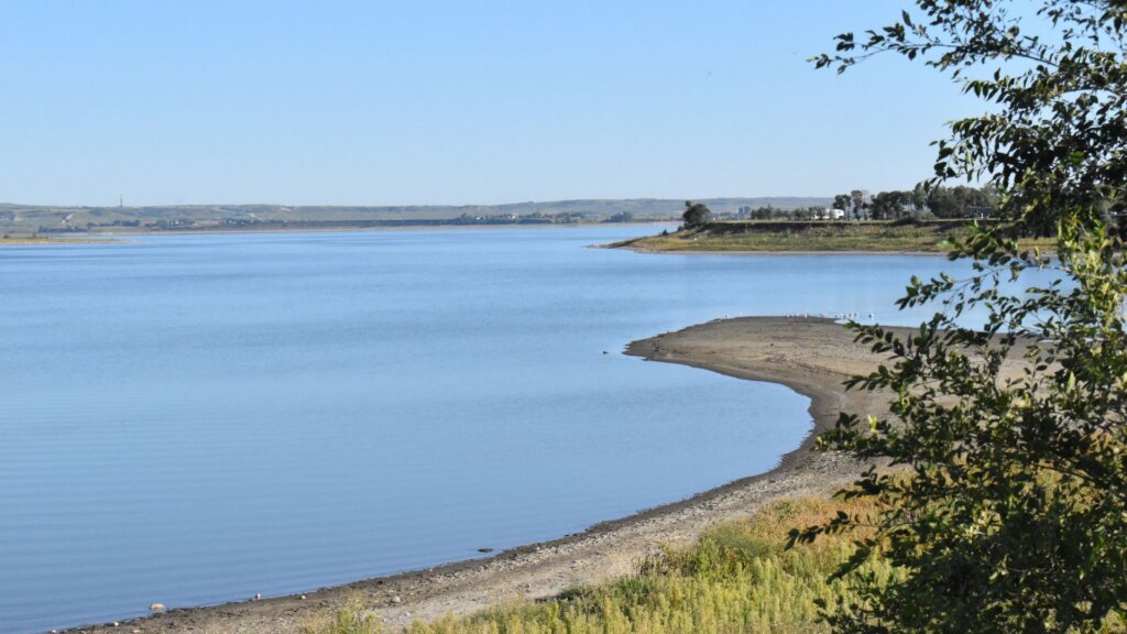 A scenic view of a North Dakota lake surrounded by wilderness.