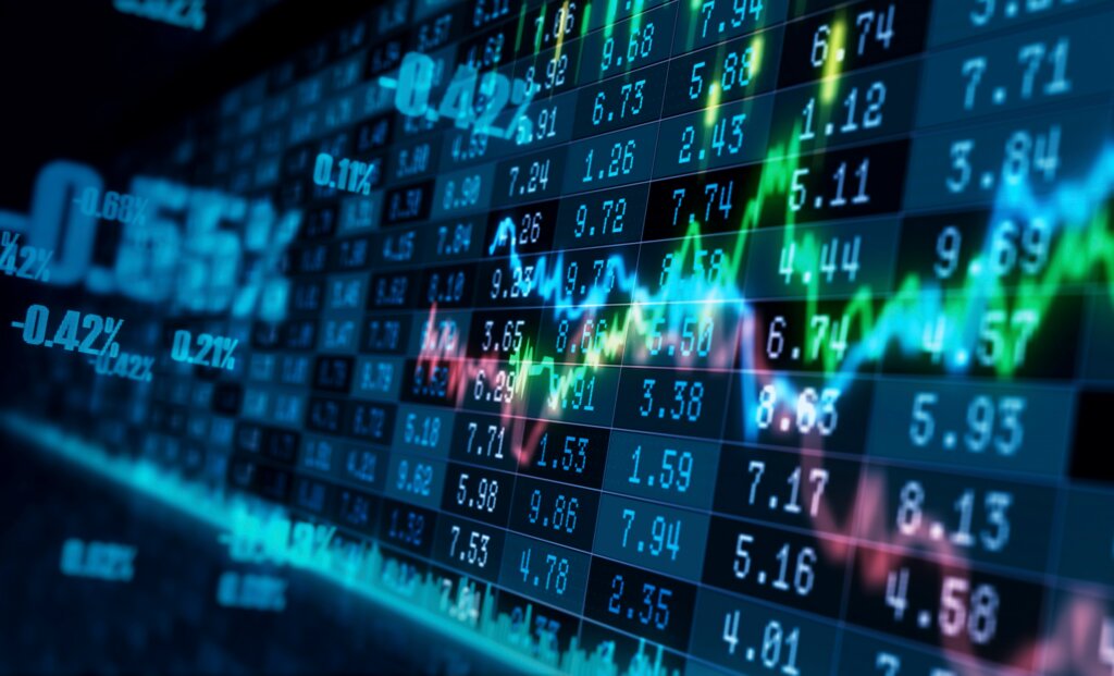 A digital stock market display shows fluctuating financial charts and trading data on an electronic screen.