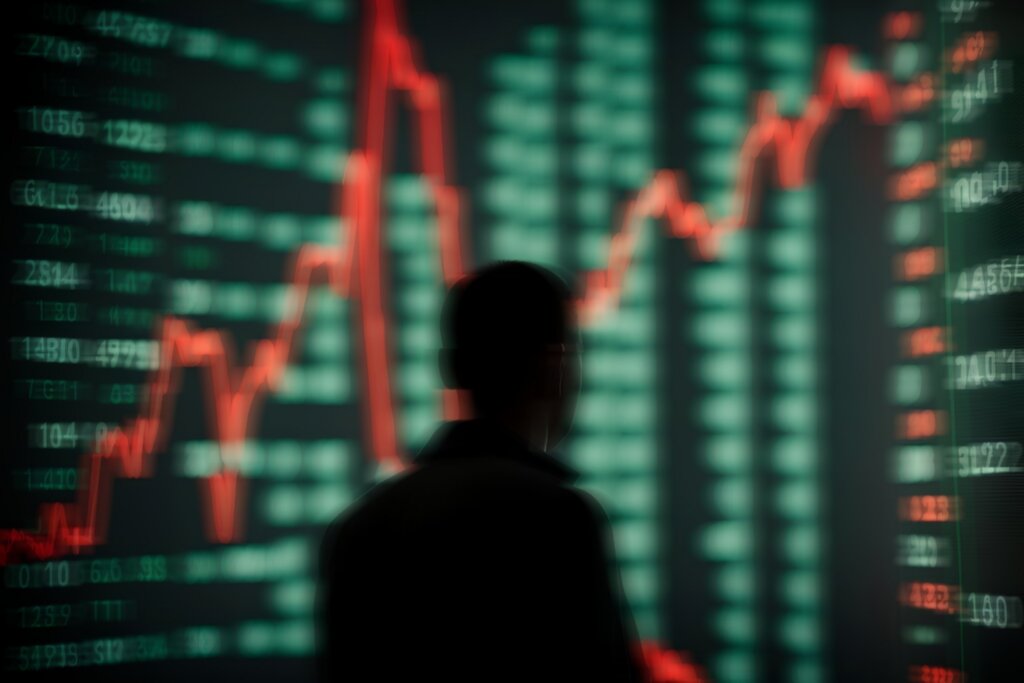 Person viewing a stock market chart displaying fluctuating financial data.