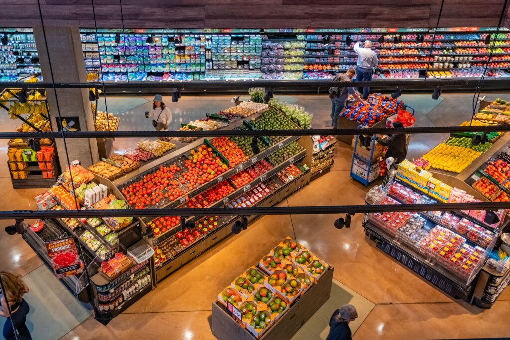 Fresh fruits and vegetables displayed in a grocery store produce section.