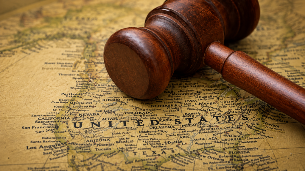 A wooden legal gavel resting on a vintage map of the United States.