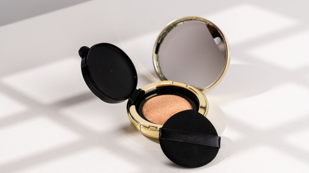 An open cushion foundation compact with an applicator pad on a light table.