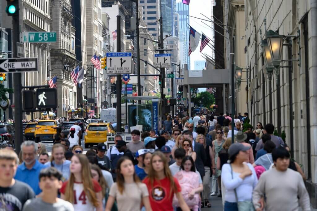 Crowds of pedestrians and traffic in a busy commercial district in the U.S.
