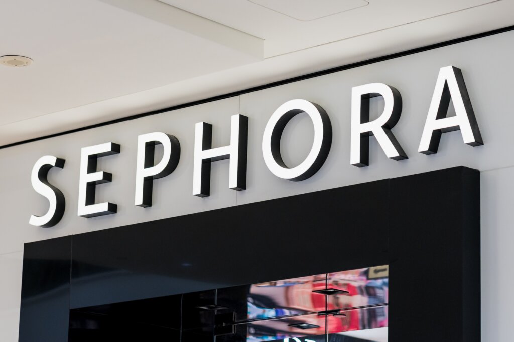 Close-up of a Sephora storefront sign with large illuminated white letters above the entrance.