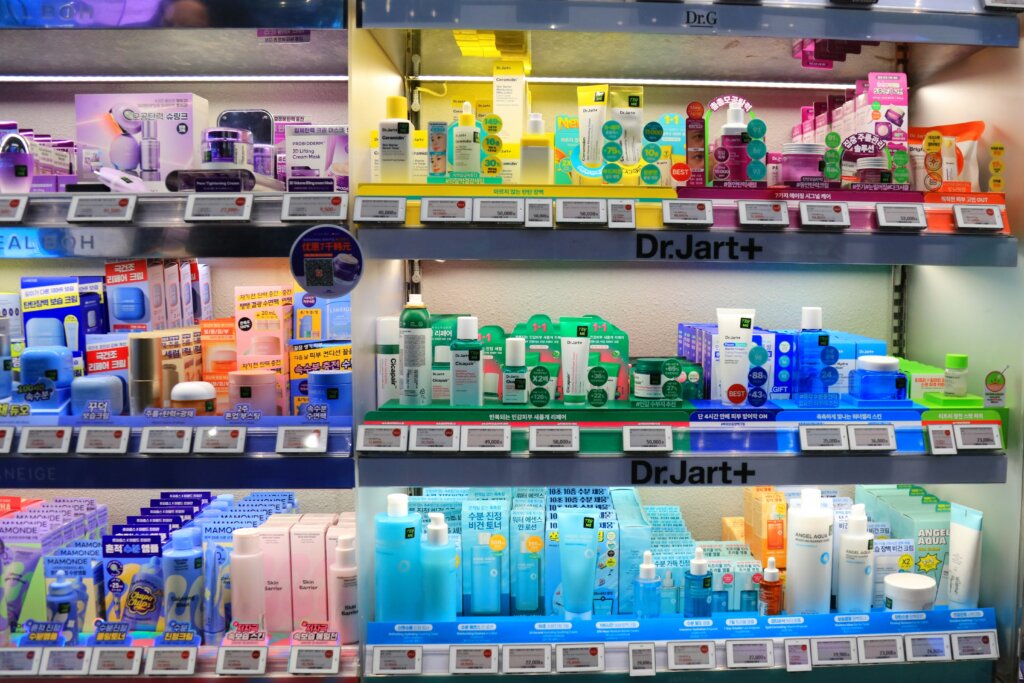 Shelves filled with colorful Korean skincare products, including Dr. Jart+ items, displayed with price tags and promotional signs.