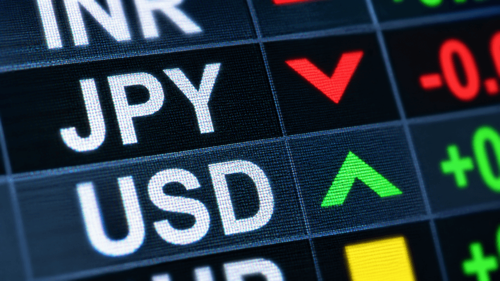 A digital financial display showing currency tickers, including Japanese Yen (JPY) trending down and US Dollar (USD) trending up.