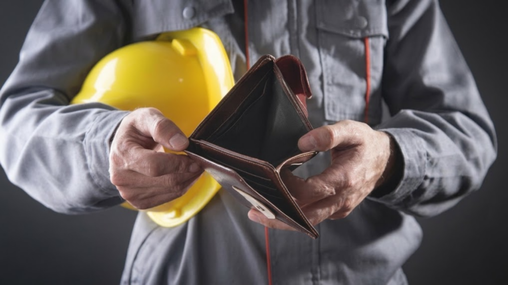 A construction worker holding an empty wallet.