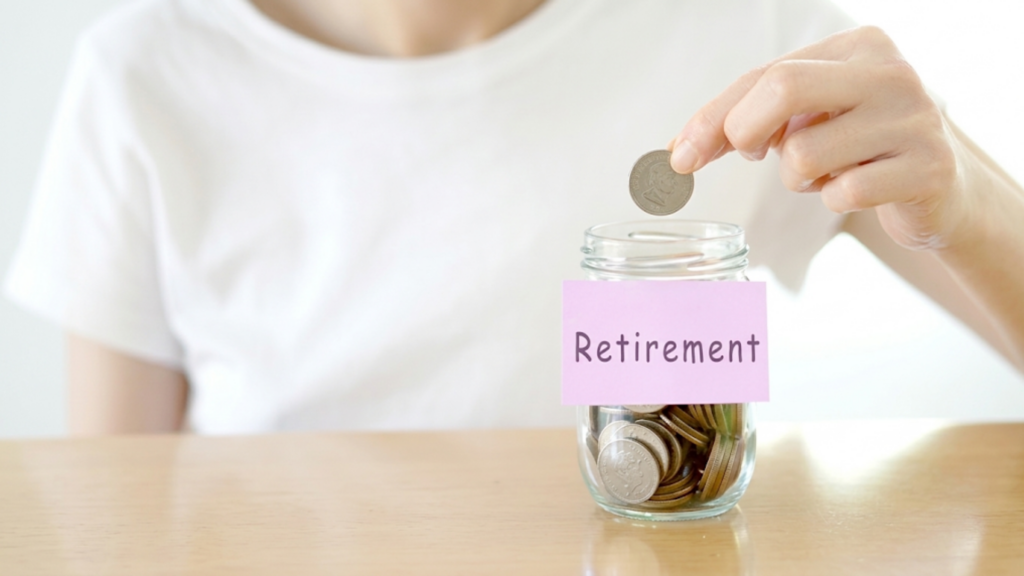 Woman depositing coins into a jar labeled "Retirement" to save for her future financial security.