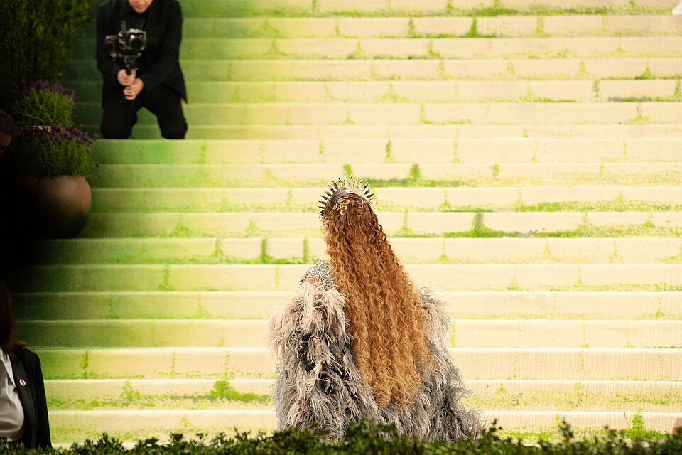 Beyoncé photographed from behind with long, voluminous curls while walking up the steps at the 2026 Met Gala.