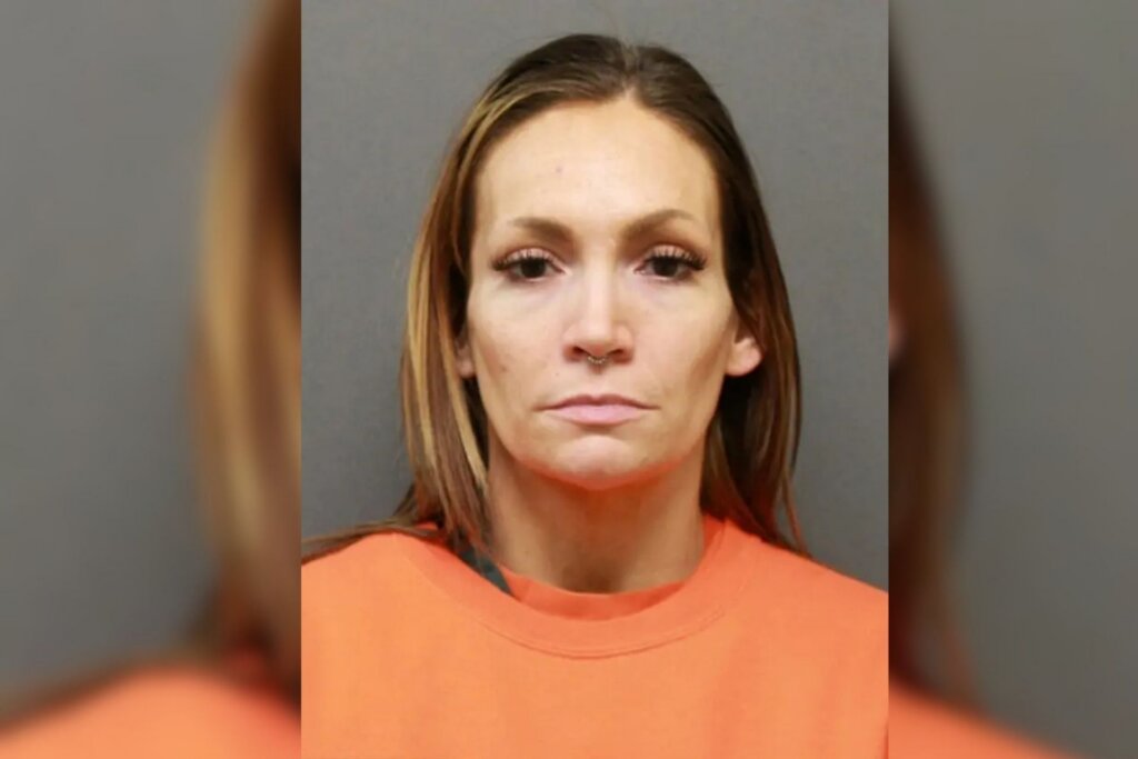 Cyrena Anne Quast pictured in a booking photo wearing an orange jail uniform.
