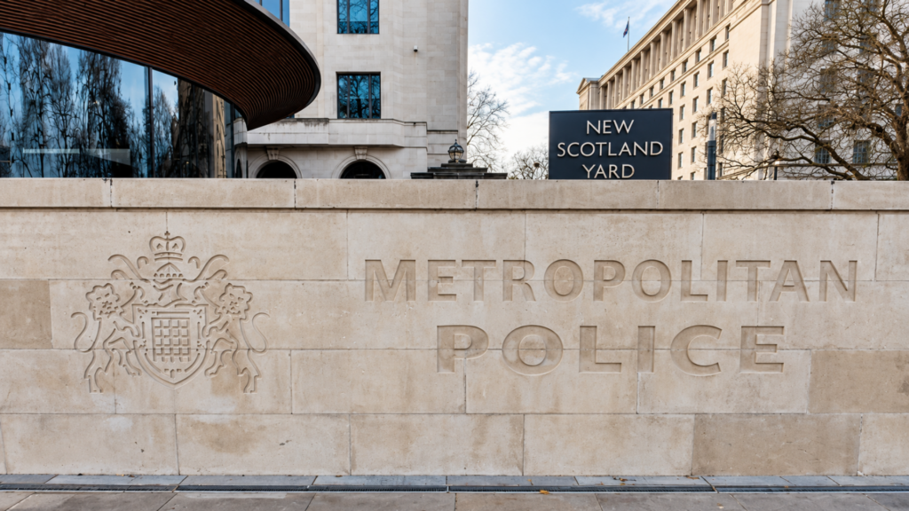 Exterior wall sign of New Scotland Yard headquarters for London's Metropolitan Police Service.