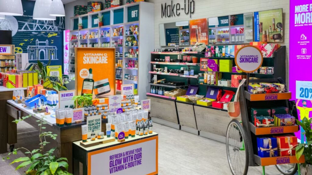 Beauty and skincare store interior featuring vitamin C skincare displays, makeup counters, and colorful beauty products.