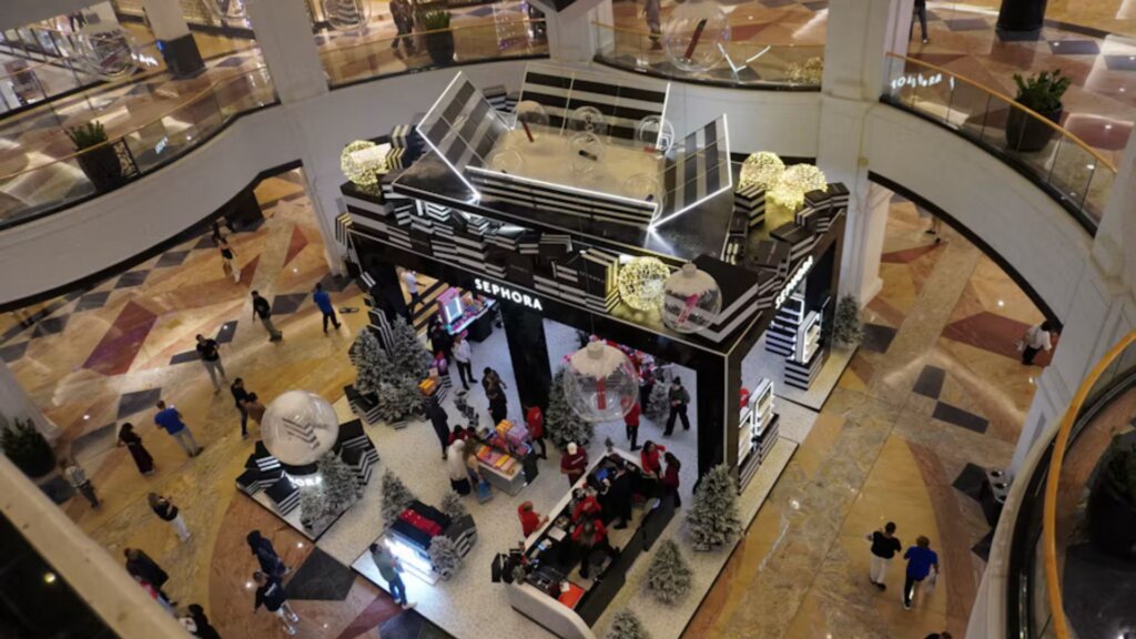 Overhead view of a Sephora cosmetics store kiosk decorated for the holidays inside a busy shopping mall.
