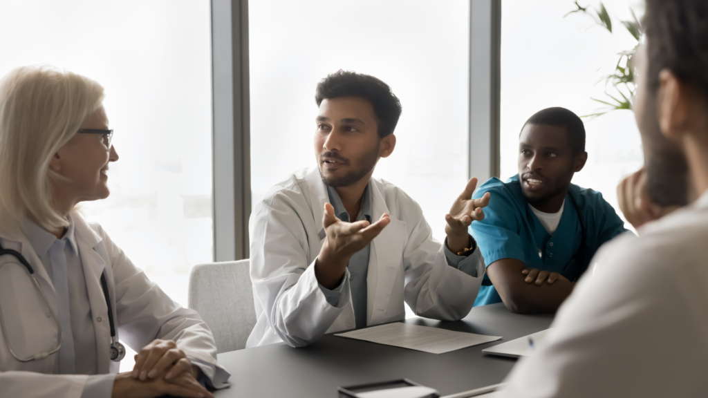 Healthcare workers in a meeting around a conference table.