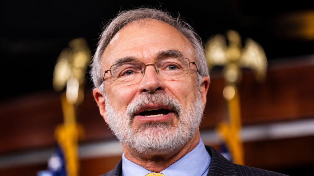 Close-up headshot of politician Andy Harris wearing rimless glasses and speaking at a podium.