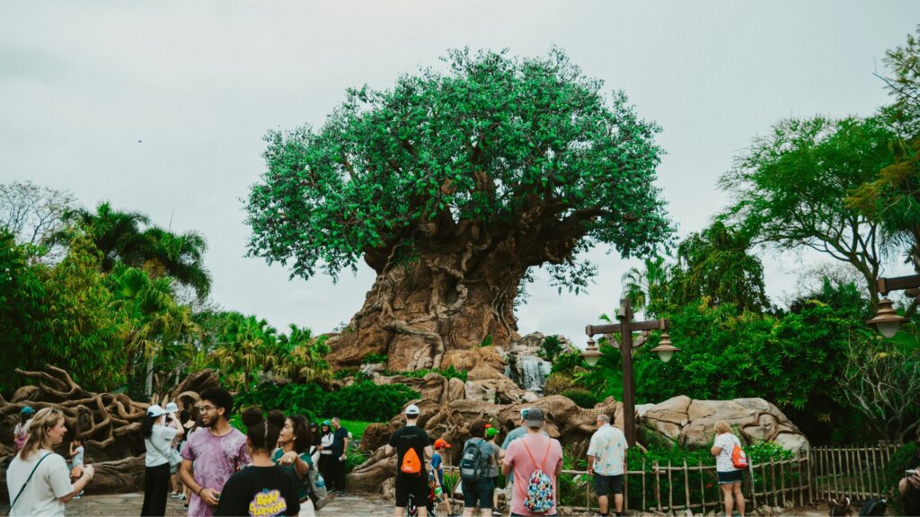 Visitors gathered at the base of the Tree of Life at Disney’s Animal Kingdom under an overcast sky.