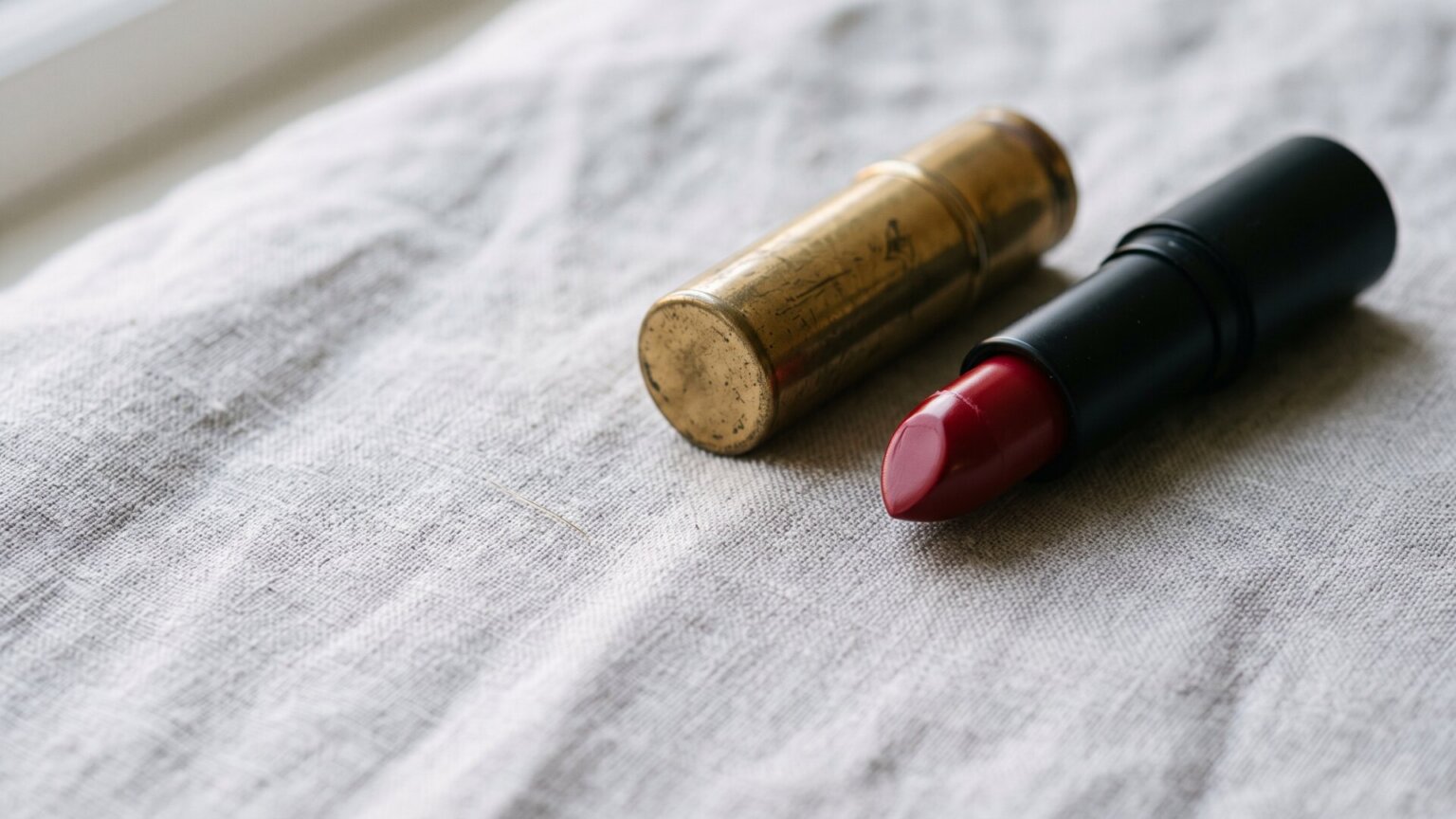 A close-up of a vintage red lipstick bullet beside a modern tube, standing for the campaign's compression of an old idea into a new format on slide 1.