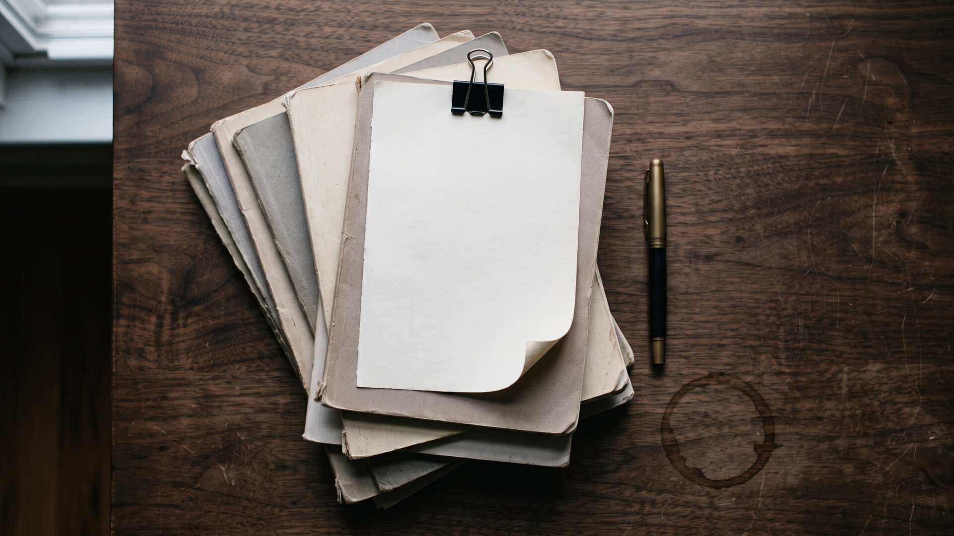 A stack of academic journal issues with a sheet of paper clipped on top, representing the retractions and concern notices in slide 6.