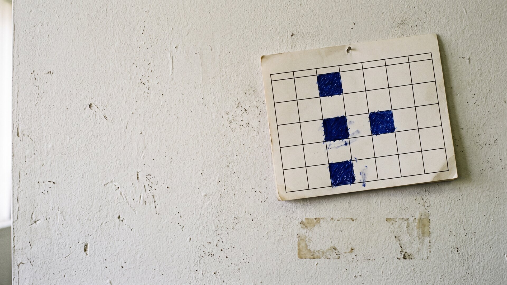 A wall-mounted calendar with four days blocked out, showing the recurring weekly load that four direct reports create as described in slide 4.