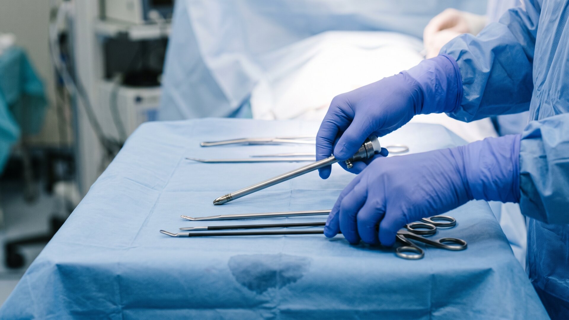 A surgical team's gloved hands preparing laparoscopic instruments, the exploratory procedure slide 3 identifies as the only definitive diagnostic method.