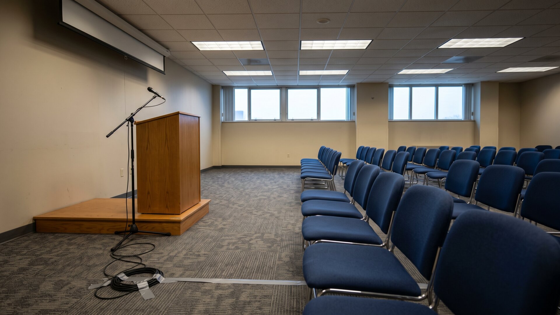 A government press briefing room before anyone speaks, matching slide 9's account of federal messaging without depicting named officials.