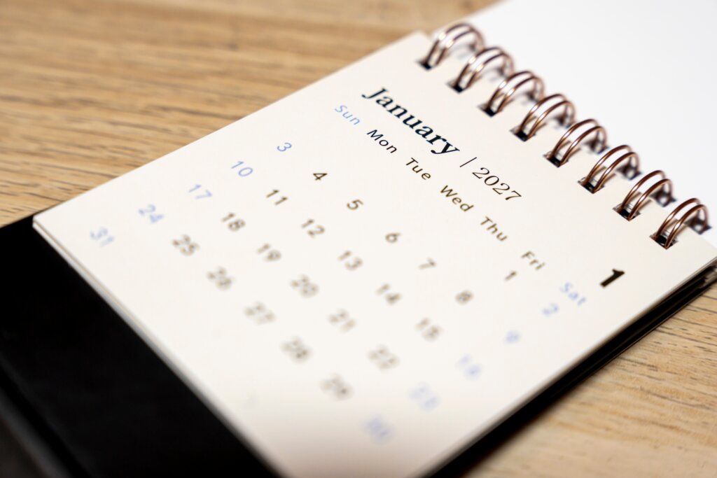 Close-up of a January 2027 calendar on a wooden desk, representing the upcoming final approval hearing for the Zumba settlement.